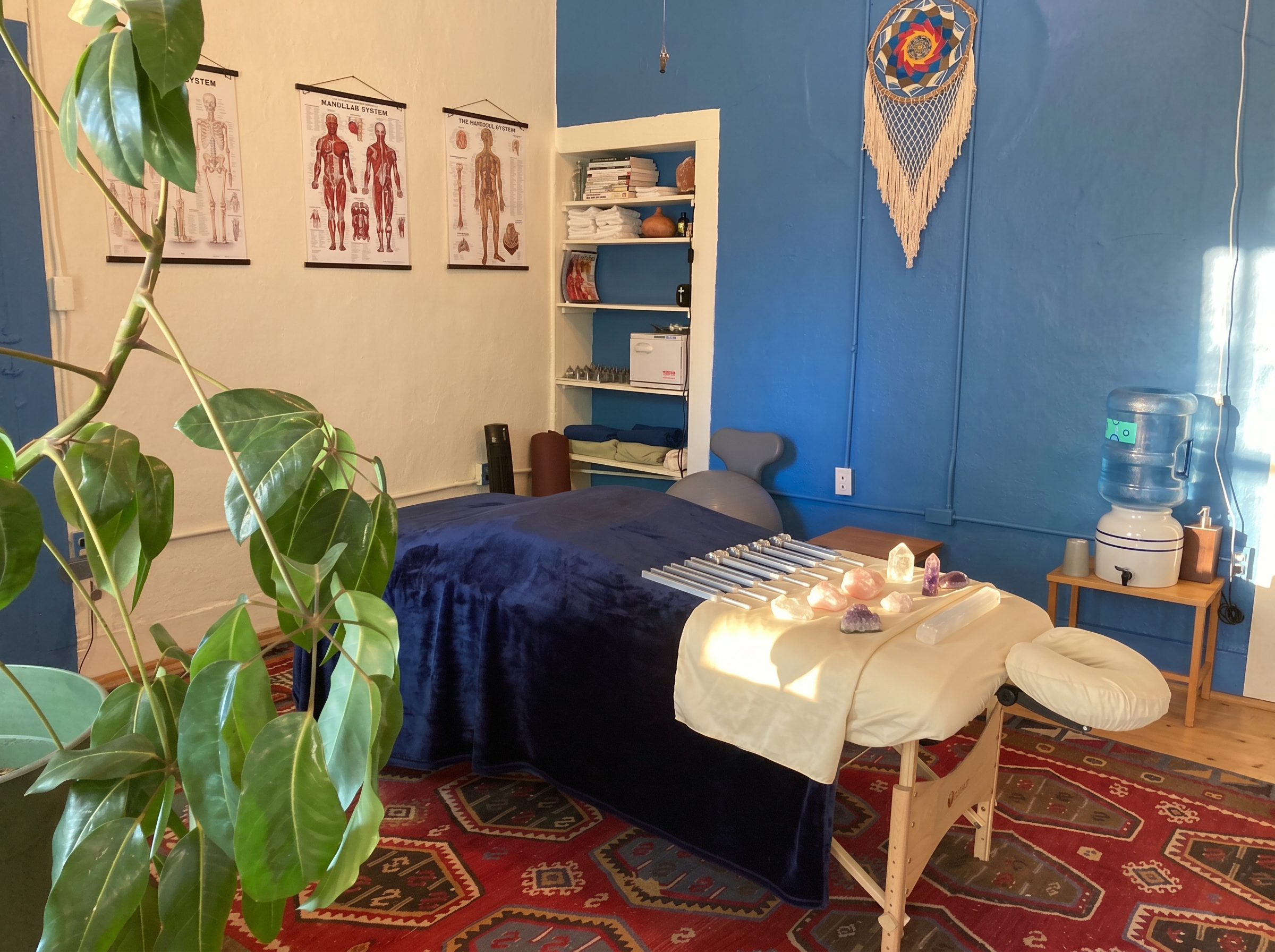 Eleanor's Taos treatment room with Solfeggio tuning forks and healing crystals arranged on the massage table