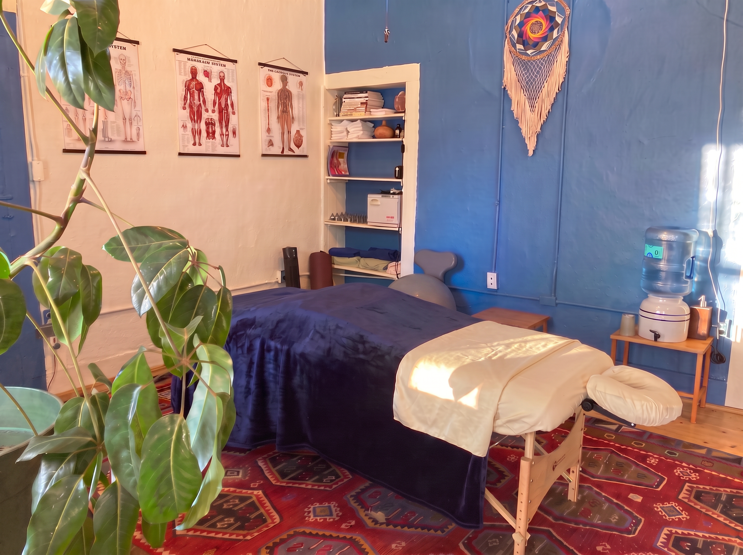 The sunlit Taos treatment room with a massage table and tuning forks, ready to welcome you